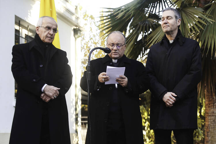 Archbishop Charles Scicluna of Malta speaks during a press conference accompanied in Santiago, Chile, June 12. He is accompanied by Father Jordi Bertomeu Farnos, right, an official of the Vatican’s doctrinal congregation. (CNS photo/Alberto Valdes, EPA) 