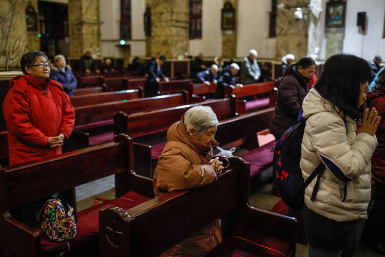 People pray during morning Mass Jan. 30 in the Cathedral of the Immaculate Conception in Beijing. (CNS photo/Roman Pilipey, EPA)