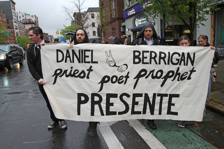 Mourners participate in a peace march on May 6 prior to the funeral Mass of Jesuit Father Daniel Berrigan in New York City (CNS photo/Gregory A. Shemitz).