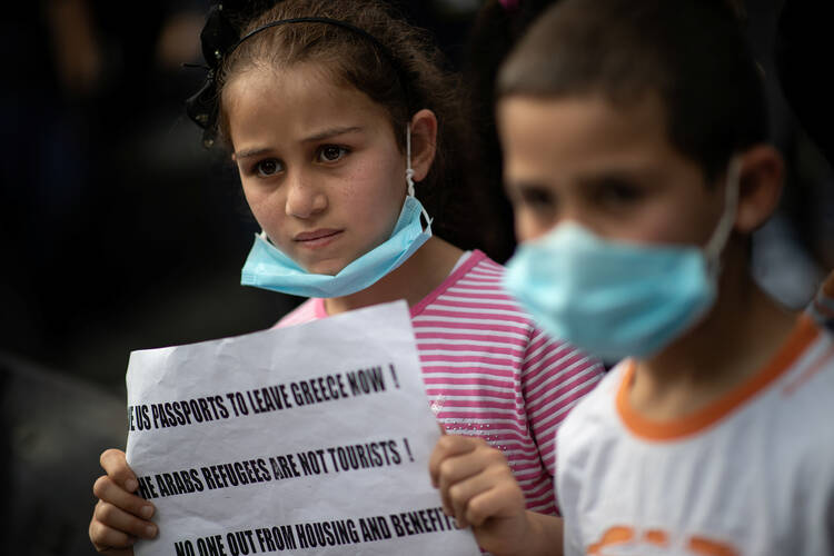 Refugee children join a protest outside the U.N. High Commissioner for Refugees office in Athens, Greece, May 29, 2020. They were protesting a government decision that they should leave their housing provided by European Union and UNHCR funds. (CNS photo/Alkis Konstantinidis, Reuters)