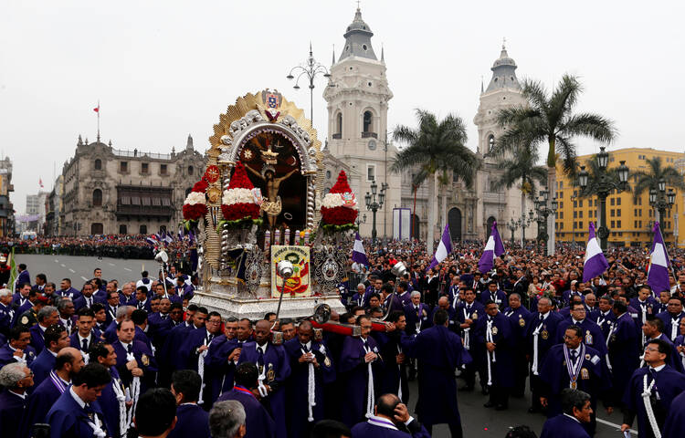Men carry a replica of Peru's most revered religious icon, the "Lord of Miracles," during an Oct. 18, 2017 procession in Lima. Each year thousands of Catholics gather to commemorate the image's survival in a 17th-century earthquake that destroyed Lima. (CNS photo/Mariana Bazo, Reuters)