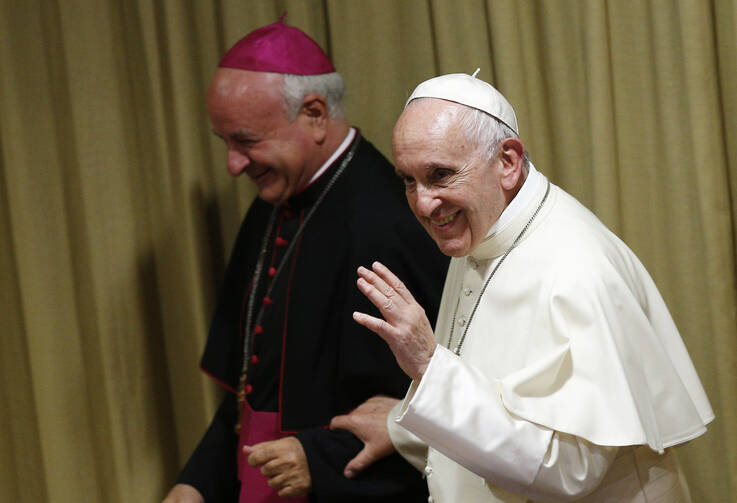 Pope Francis leaves with Archbishop Vincenzo Paglia, president of the Pontifical Academy for Life, after addressing the general assembly of the academy at the Vatican, Oct. 5 (CNS photo/Paul Haring).