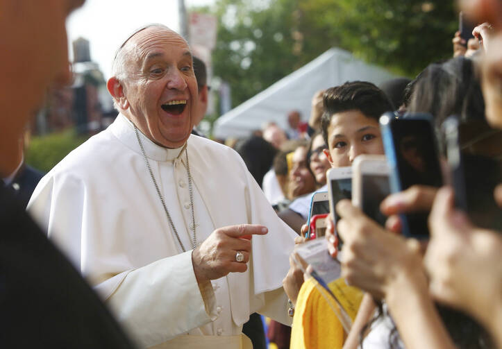 Pope Francis greets children outside Our Lady Queen of Angels School in the East Harlem area of New York Sept. 25, 2015 (CNS photo/Eric Thayer).