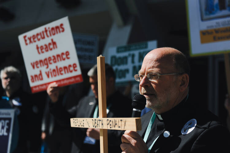 Father Chris Ponnet, chaplain at the St. Camillus Center for Spiritual Care in Los Angeles, speaks during a rally protesting the death penalty in Anaheim, Calif., Feb. 25, 2017. (CNS photo/Andrew Cullen, Reuters) 