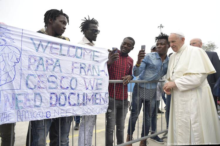 Pope Francis greets people at the “Regional Hub,” a government-run processing center for migrants, refugees and asylum seekers, in Bologna, Italy, Oct. 1. (CNS photo/L’Osservatore Romano)