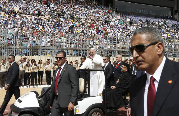 Pope Francis greets the crowd as he arrives to celebrate Mass at the Air Defense Stadium in Cairo April 29. (CNS photo/Paul Haring)