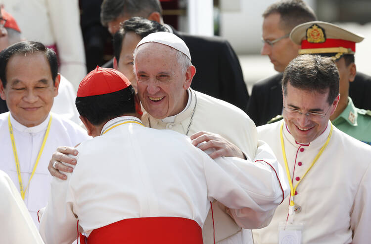 Pope Francis greets Cardinal Charles Bo of Yangon as he arrives at Yangon International Airport in Yangon, Myanmar, Nov. 27 (CNS photo/Paul Haring).