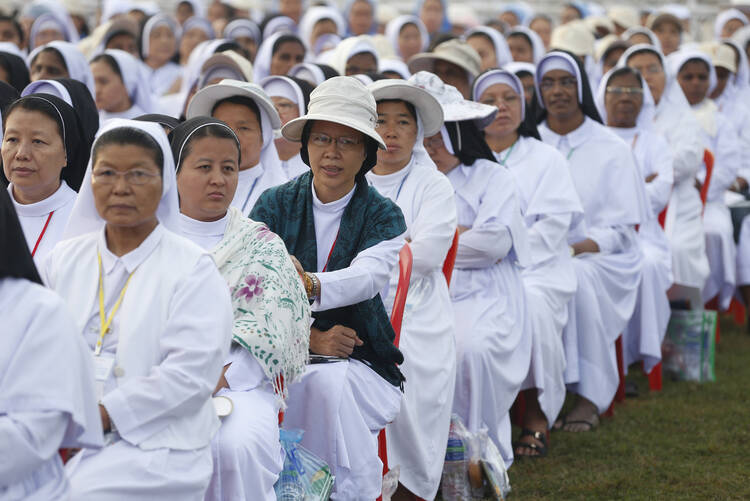 Nuns wait for the start of Pope Francis' celebration of Mass at Kyaikkasan sports ground in Yangon, Myanmar, Nov. 29. (CNS photo/Paul Haring)