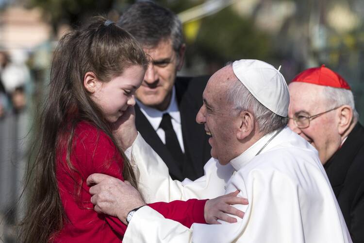 Pope Francis greets a girl during a March 12 visit at the Rome parish of St. Magdalene of Canossa. (CNS photo/Angelo Carconi, EPA)