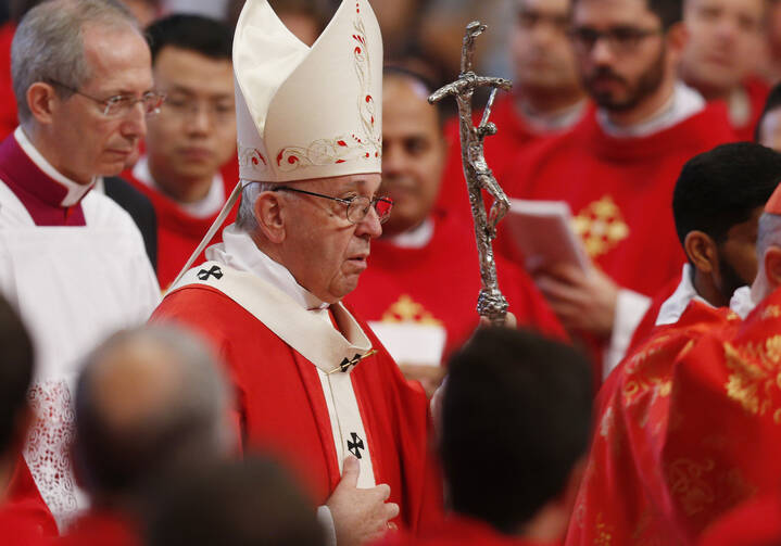  Pope Francis arrives in procession to celebrate Mass marking the feast of Pentecost in St. Peter's Basilica at the Vatican May 20. The pope at his "Regina Coeli" announced that he will create 14 new cardinals June 29. (CNS photo/Paul Haring)