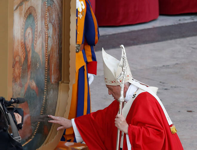 Pope Francis touches a Marian icon as he leaves at the end of a vigil, ahead of Pentecost Sunday, at the Vatican June 8, 2019. (CNS photo/Remo Casilli, Reuters)