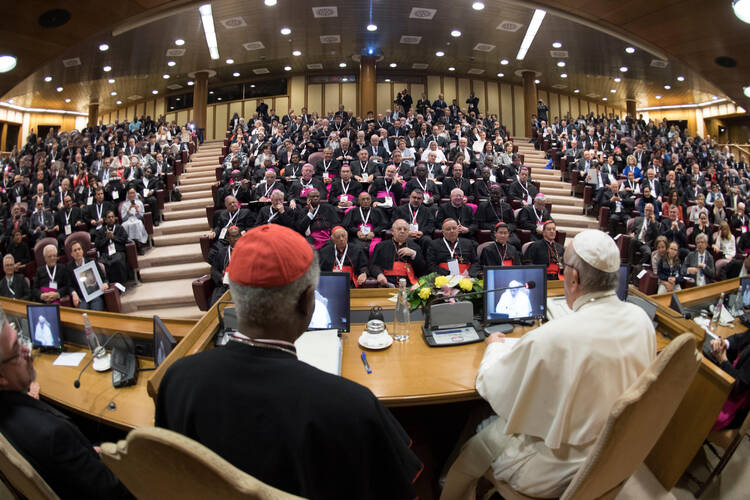 Pope Francis speaks on April 4 to participants at a Vatican conference marking the 50th anniversary of Blessed Paul VI's encyclical on development, "Populorum Progressio." At left is Cardinal Peter Turkson, president of the Pontifical Council for Justice and Peace (CNS photo/L'Osservatore Romano, handout).