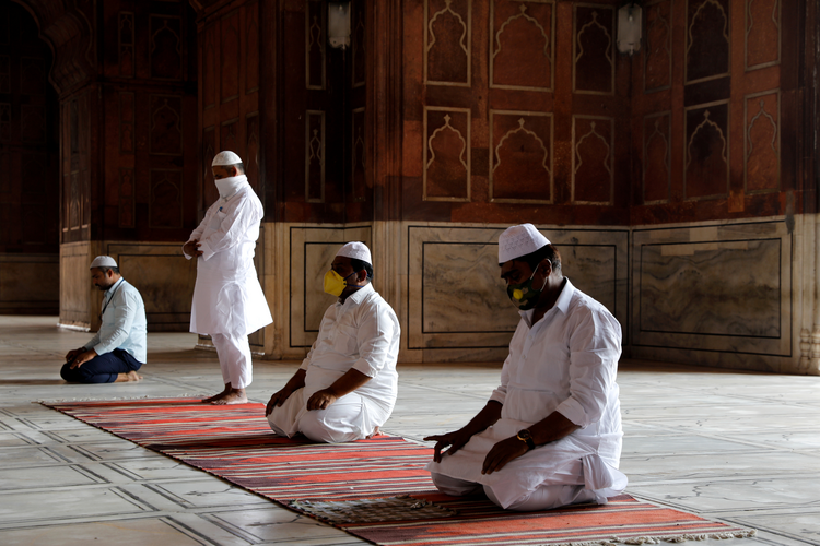 Image: Muslim men wearing masks offer prayers at a mosque on the first Friday of Ramadan, May 1, during the coronavirus pandemic in New Delhi. (CNS photo/Anushree Fadnavis, Reuters)
