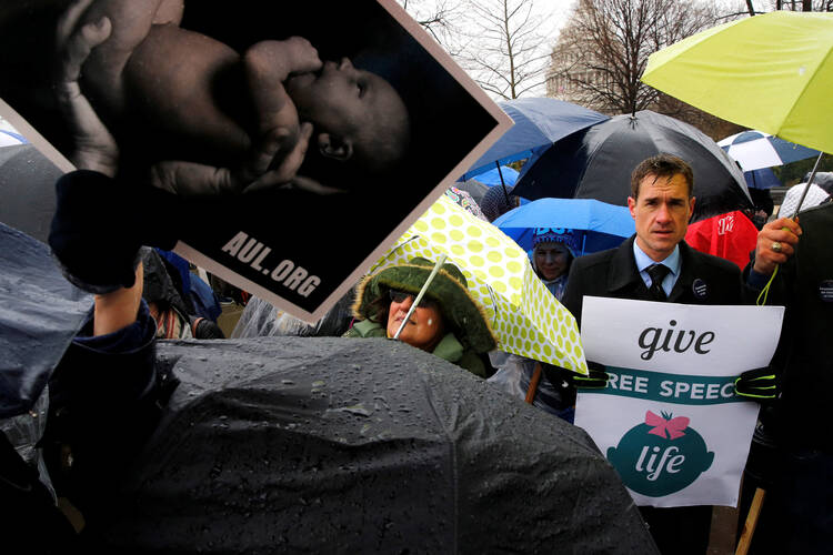 A pro-life advocate holds a sign during a March 20 rally outside the U.S. Supreme Court in Washington (CNS photo/Jonathan Ernst, Reuters). 