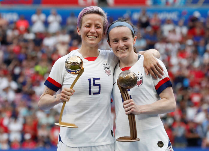 Megan Rapinoe and Rose Lavelle of the U.S. celebrate being awarded the golden ball and bronze ball after winning the FIFA Women's World Cup in Lyon, France, July 7, 2019. Lavelle is a graduate of Mount Notre Dame High School in Reading, Ohio. (CNS photo/Bernadett Szabo, Reuters)