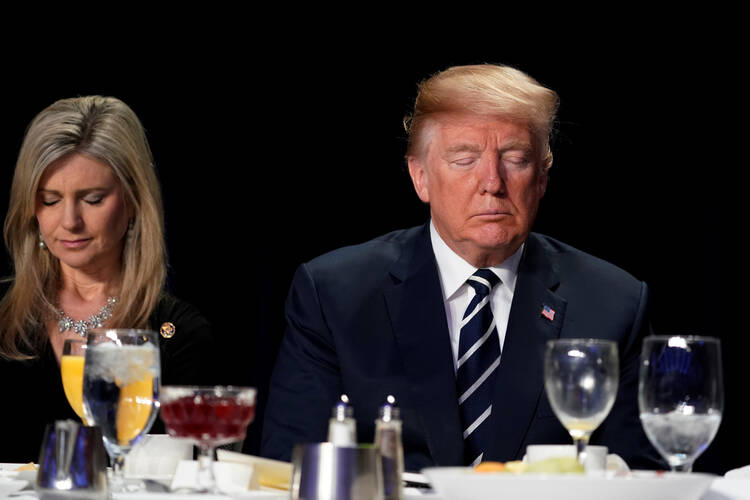  U.S. President Donald Trump prays during the National Prayer Breakfast Feb. 8 in Washington. (CNS photo/Jonathan Ernst, Reuters)