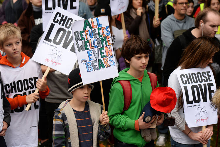 Young demonstrators gather outside Parliament in London Oct. 24 to call for more child refugees to be allowed asylum and safe passage to the United Kingdom. (CNS photo/Mary Turner, Reuters)