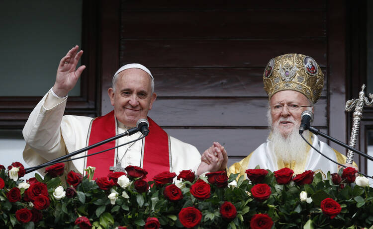 Pope Francis and Ecumenical Patriarch Bartholomew of Constantinople greet a small crowd after delivering a blessing in 2014 in Istanbul (CNS photo/Paul Haring).