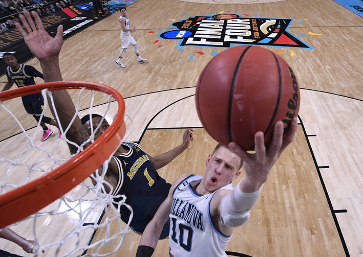 Michigan Wolverines guard Charles Matthews tries to defend a shot from Villanova Wildcats guard Donte DiVincenzo in the NCAA men's basketball championship April 2 in San Antonio. Villanova defeated Michigan, 79-62, winning its second championship in three years. (CNS photo/ Robert Deutsch, USA TODAY Sports via Reuters)