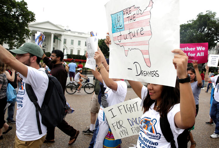 People march outside the White House Aug. 15 at a rally calling on President Donald Trump to protect the Deferred Action for Childhood Arrivals program, known as DACA. (CNS photo/Joshua Roberts, Reuters) 