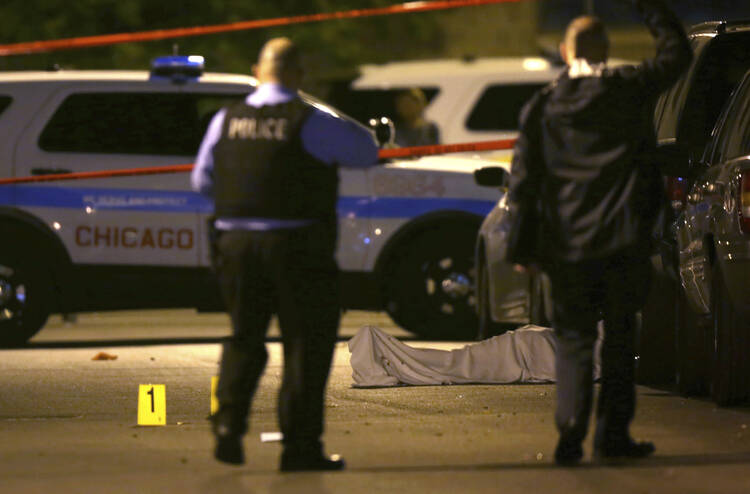 In this May 30, 2016 file photo, police work the scene where a man was fatally shot in the chest in Chicago (E. Jason Wambsgans/Chicago Tribune via AP).
