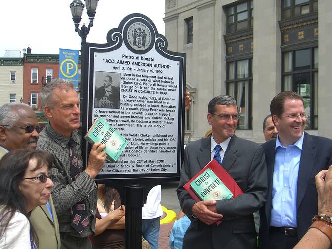 The dedication ceremony of Pietro di Donato, Plaza in Union City, New Jersey, May 22, 2010. Holding up a copy of di Donato’s novel, Christ in Concrete, is the author’s son, Richard (Wikicommons/Luigi Novi).