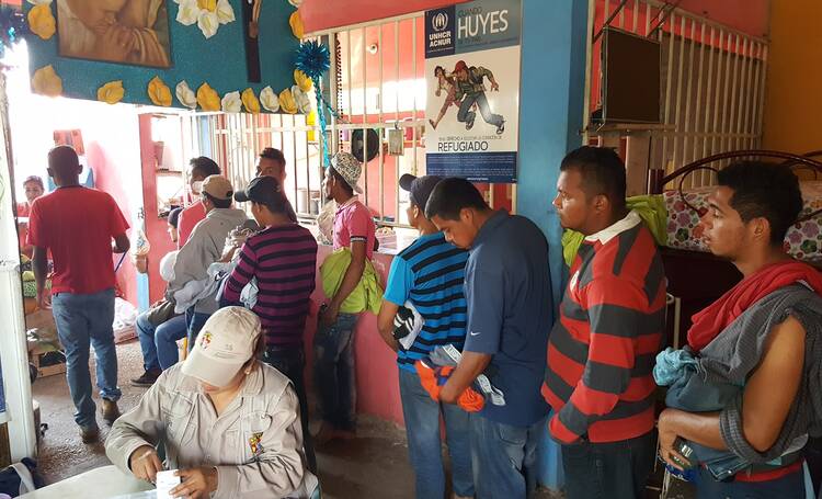 Migrant men line up for a health check in at the shelter in Coatzacoalcos, Mexico, on Jan. 26, 2017. Photo: Jan-Albert Hootsen