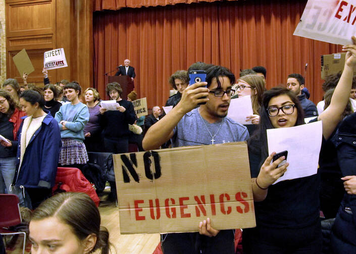 Middlebury College students turn their backs to author Charles Murray during his lecture in Middlebury, Vt. The college says it has initiated an independent investigation into the protest in which the author of a book discussing racial differences in intelligence was shouted down during the guest lecture and a professor was injured. (AP Photo/Lisa Rathke, File)