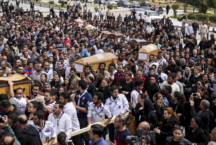 Coffins arrive for the funeral of those killed in a Palm Sunday church attack in Alexandria Egypt, at the Mar Amina Church, Monday, April 10, 2017. Egyptian Christians buried their dead on Monday, a day after Islamic State suicide bombers killed at least 45 people in coordinated attacks targeting Palm Sunday services in two cities. (AP Photo/Samer Abdallah)