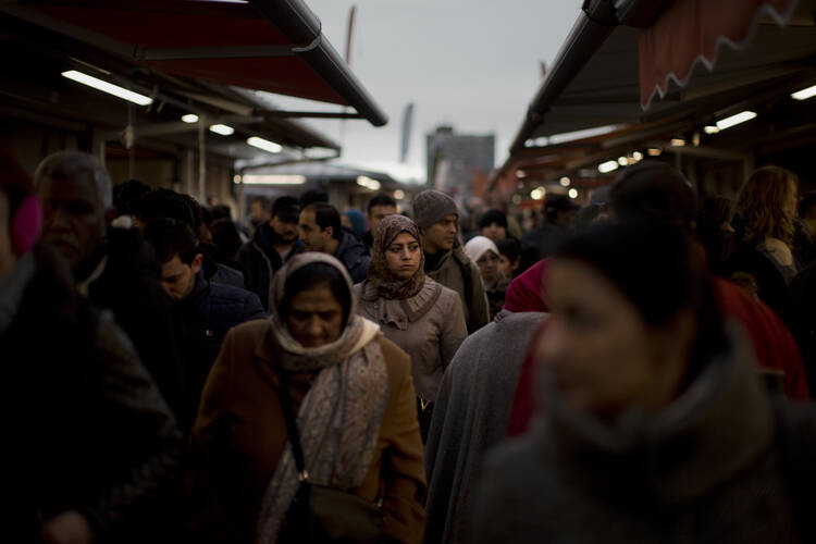 In this Saturday, March 4, 2017 photo, people walk along street stalls at a fruit market in The Hague, The Netherlands. (AP Photo/Emilio Morenatti)