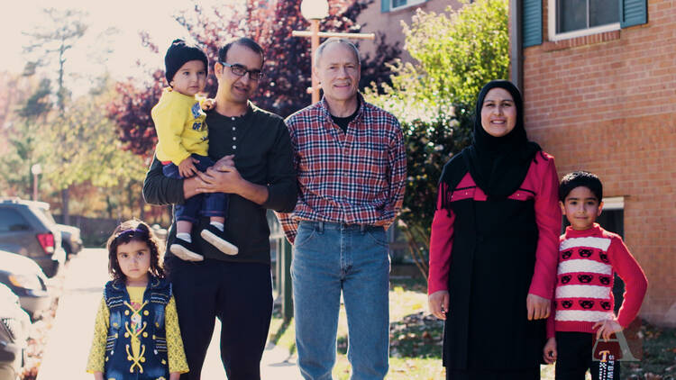 Rich McKinless with Rahim and Rayhanna Ibrahimi, and their three children, Layma, Hamza and Hasib