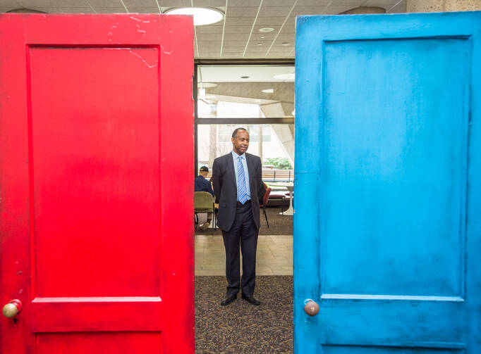 Housing and Urban Development Secretary Ben Carson inspects the federal department’s Fair Housing Door Exhibit marking the 50th anniversary of the Fair Housing Act. (U.S. Dept. of Housing and Urban Development, via Wikimedia Commons)