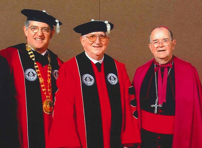 Dr. Joseph J. McGowan, president of Bellarmine University, Patrick Hart, O.C.S.O., and Archbishop Thomas Kelly during the ceremony at which Brother Hart received an honorary degree from Bellarmine University on May 10, 2003. (Courtesy of Bellarmine University)