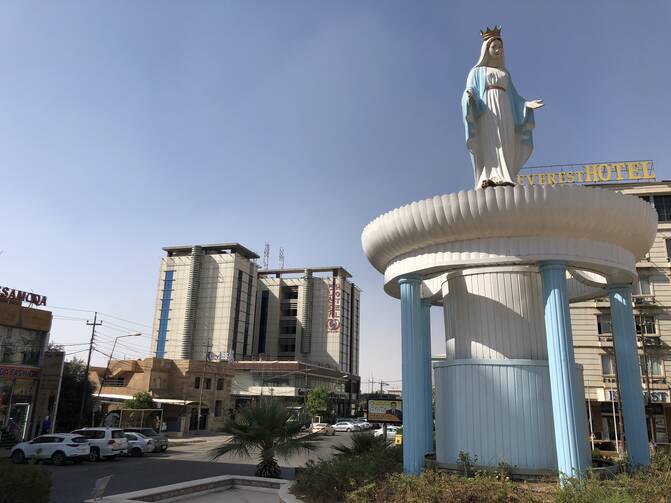 “Mother Mary” gazes serenely down on the traffic fuming and stalling around her in Ankawa, a suburb of Erbil. (Kevin Clarke)