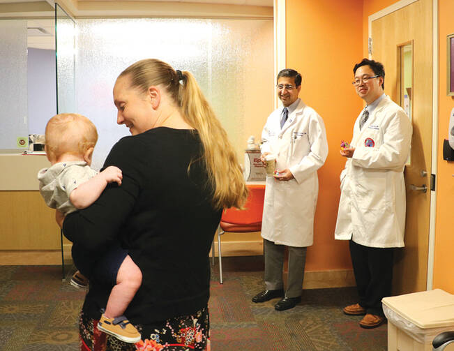 Nine-month-old Conner Walkenhorst and his mother, Jennifer Walkenhorst, visit in July 2017 with Dr. Nadeem Parkar and Dr. Wilson King, physicians instrumental in the creation of a three-dimensional model of Conner’s heart at SSM Health Cardinal Glennon Children’s Hospital in St. Louis. The model allowed for detailed planning of the baby’s successful heart transplant surgery. (Betsy Taylor/CHA)