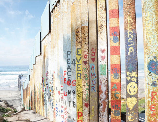Residents of Tijuana, Baja California, Mexico, decorate the southern side of the barrier at the border with messages of peace and love. (J.D. Long-García)