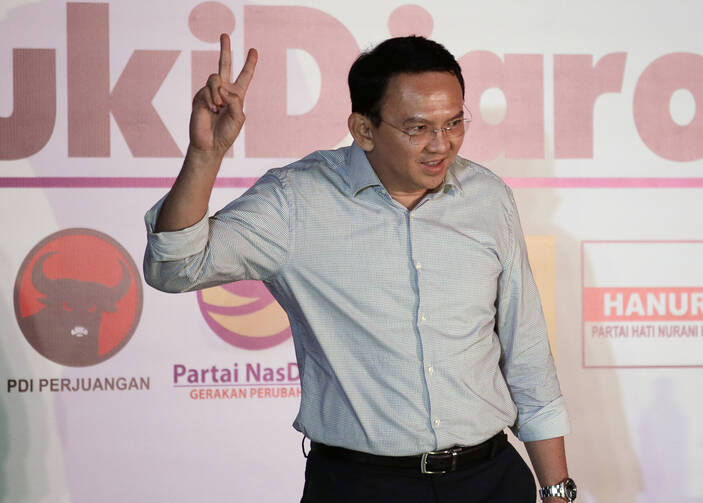 Jakarta Governor Basuki "Ahok" Tjahaja Purnama flashes a "V" sign during a press conference in Jakarta, Indonesia, Wednesday, April 19, 2017. Unofficial results showed the minority Christian governor was resoundingly defeated Wednesday by his Muslim challenger, after a campaign that cracked open religious and racial divides in the world's most populous Muslim nation. (AP Photo/Dita Alangkara)