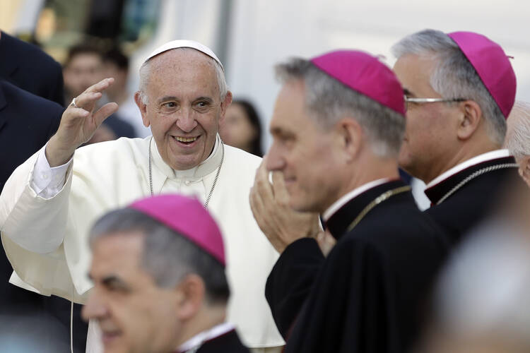 Pope Francis greets bishops as he arrives at Bozzolo, near Cremona, northern Italy, to pray at the tomb of Don Primo Mazzolari, on Tuesday, June 20, 2017. Pope Francis is making a pilgrimage to northern Italy to honor two 20th-century parish priests whose commitment to the poor and powerless brought them censure from the Vatican. (AP Photo/Antonio Calanni)