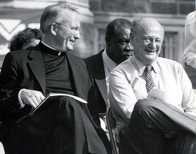 Father O’Hare shares a laugh with New York Mayor Ed Koch. Photo courtesy of Fordham University