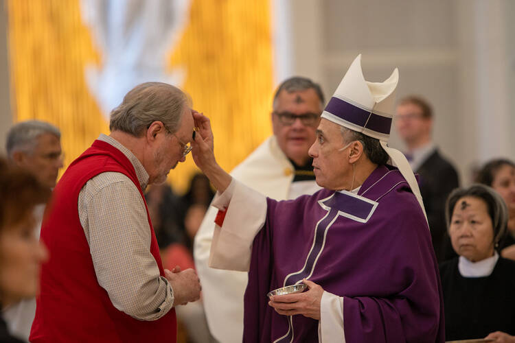 Cardinal Daniel N. DiNardo of Galveston-Houston, who is president of the U.S. Conference of Catholic Bishops, distributes ashes on Ash Wednesday at the Co-Cathedral of the Sacred Heart in Houston March 6, 2019. (CNS photo/James Ramos, Texas Catholic Herald)