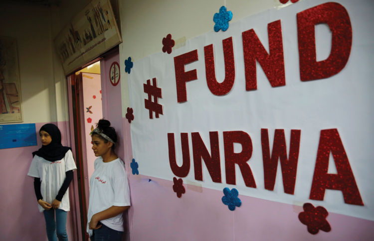 Palestinian refugee students stand outside a classroom in Beirut, Lebanon, on Sept. 3. (AP Photo/Hussein Malla)