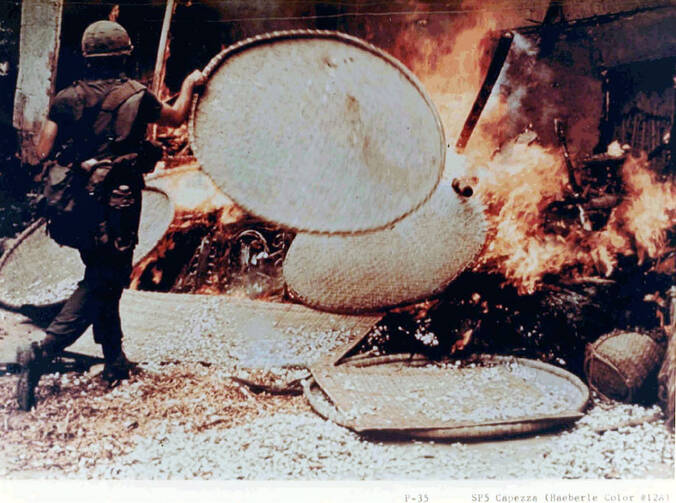  Specialist Capezza. My Lai, Vietnam. March 16, 1968. PFC Capezza shown setting a fire during the My Lai massacre, in which between 300 and 500 Vietnamese civilians were killed. Photo by Ronald Haberle