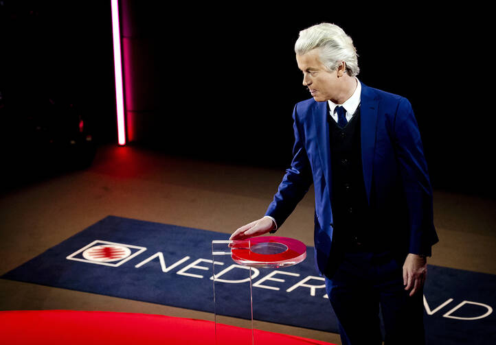 Right-wing populist leader Geert Wilders walks onto the stage in the closing debate at parliament in The Hague, Netherlands on Tuesday, March 14, 2017. (Remko de Waal ANP POOL via AP)