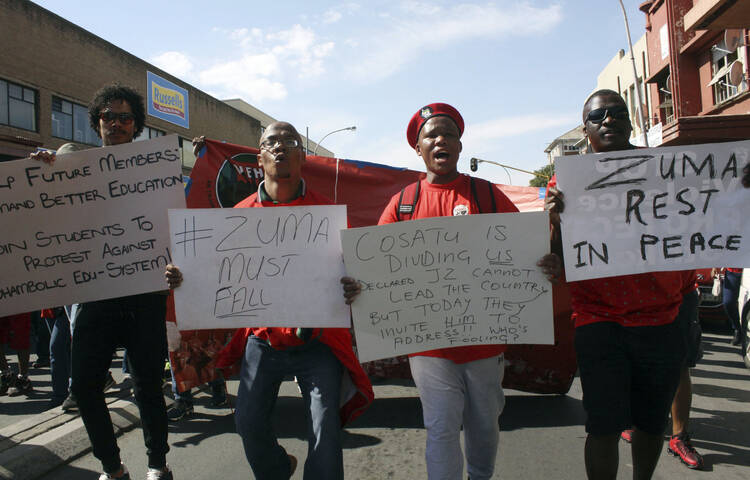 At a May Day rally in Bloemfontein, South Africa, trade unionists demand that South African President Jacob Zuma step down. The president was jeered by labor activists and his speech was cancelled after scuffles broke out between his supporters and workers chanting for him to step down at the rally. (AP Photo/Khothatso Mokone)
