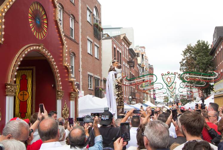 Members of the Society of San Antonio di Padua da Montefalcione carry the statue of St. Anthony on Aug. 23 in Boston's North End neighborhood. (Angelo Jesus Canta)