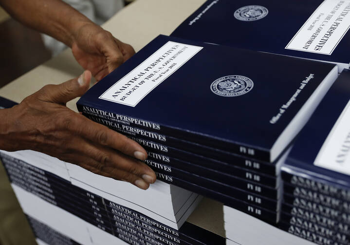 In this photo taken May 19, 2017, a GPO worker stacks copies of "Analytical Perspectives Budget of the U.S. Government Fiscal Year 2018" onto a pallet at the U.S. Government Publishing Office's (GPO) plant in Washington. (AP Photo/Carolyn Kaster)