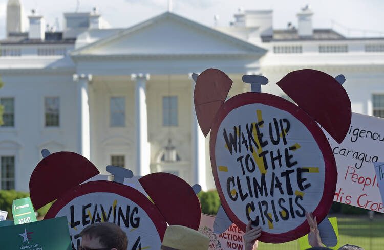 Protesters gather outside the White House in Washington on June 1 to protest President Donald Trump's decision to withdraw the Unites States from the Paris climate change accord. (AP Photo/Susan Walsh)