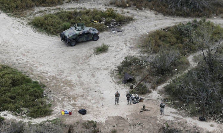 In this Feb. 24, 2015, file photo, members of the National Guard patrol along the Rio Grande at the Texas-Mexico border in Rio Grande City, Texas. (AP Photo/Eric Gay, File)