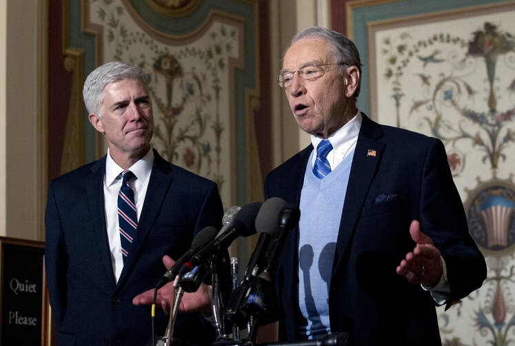 Supreme Court Justice nominee Neil Gorsuch listens at left as Senate Judiciary Committee Sen. Chuck Grassley, R-Iowa speaks on Capitol Hill in Washington, Wednesday, Feb. 1, 2017. (AP Photo/Jose Luis Magana)