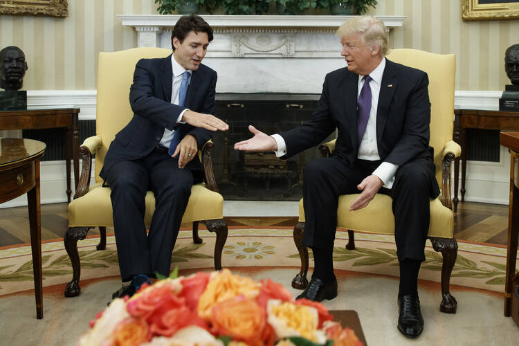 Canadian Prime Minister Justin Trudeau reaches for the hand of President Donald Trump in the Oval Office of the White House on Feb. 13, 2017. (AP Photo/Evan Vucci)